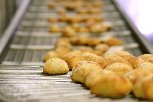 Freshly baked Chabaso rolls on conveyor belt